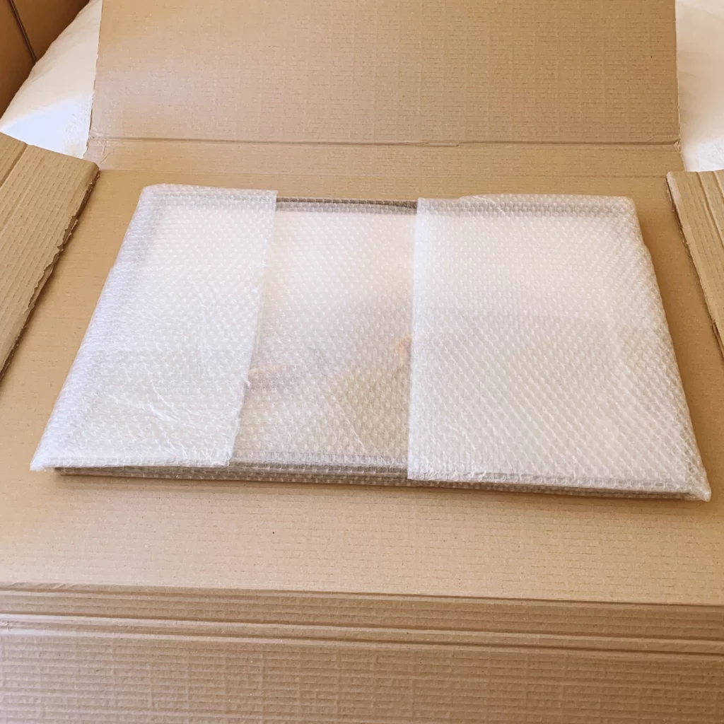 Tirage emballé dans son double carton sur mesure